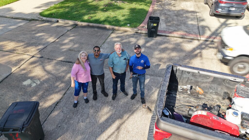 Apollo Roofing team members with homeowners after a residential roofing project.