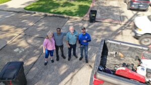 Apollo Roofing team members with homeowners after a residential roofing project.